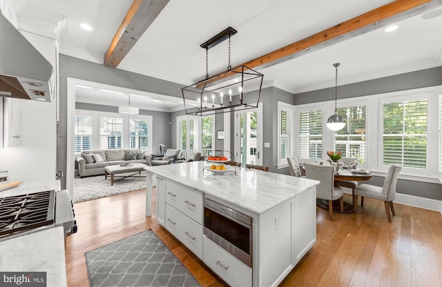 4416 Stanford St, Chevy Chase, MD 20815 - kitchen featuring wall chimney range hood, light wood-style floors, white cabinets, and beamed ceiling