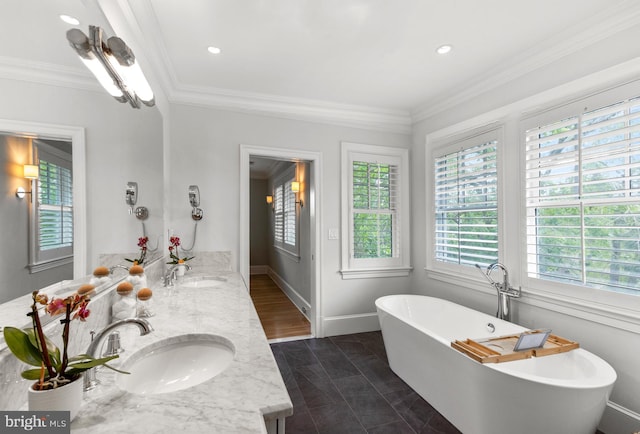 4416 Stanford St, Chevy Chase, MD 20815 - bathroom with double vanity, a sink, a freestanding tub, and crown molding
