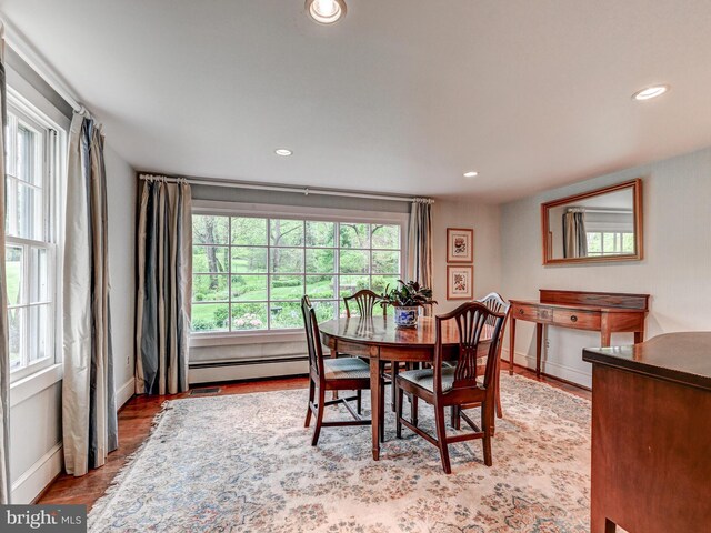 dining room with a baseboard heating unit, recessed lighting, and baseboards