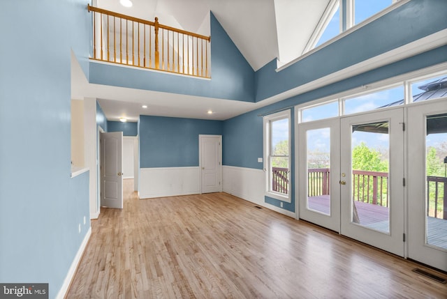 interior space with visible vents, plenty of natural light, french doors, and wood finished floors