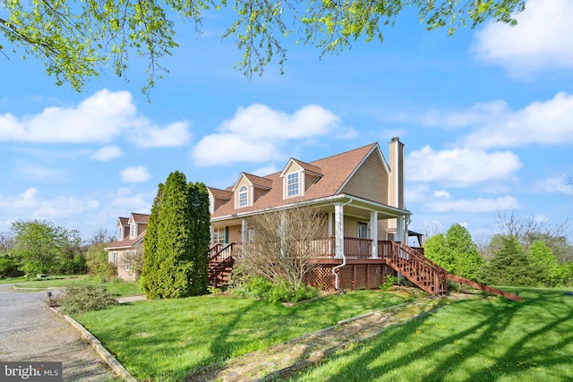 view of property exterior with a chimney, a yard, a porch, and stairway