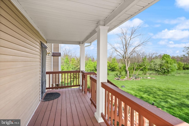 deck with a porch and a lawn