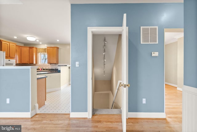 kitchen featuring visible vents, track lighting, freestanding refrigerator, recessed lighting, and light wood-style flooring