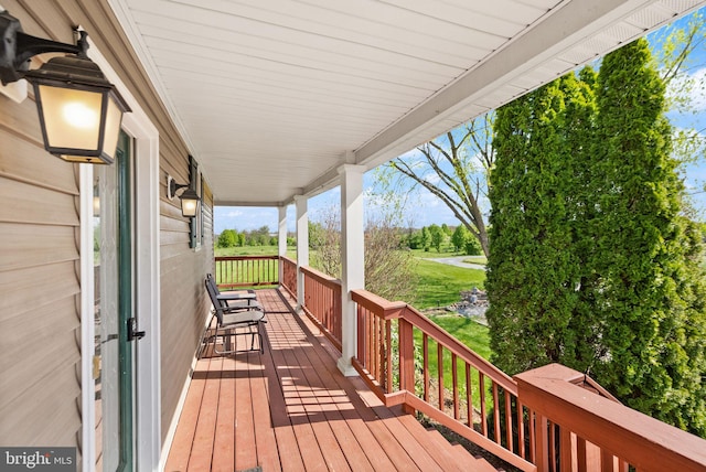wooden terrace featuring covered porch