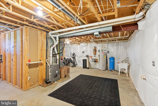 unfinished below grade area featuring heating unit and electric water heater
