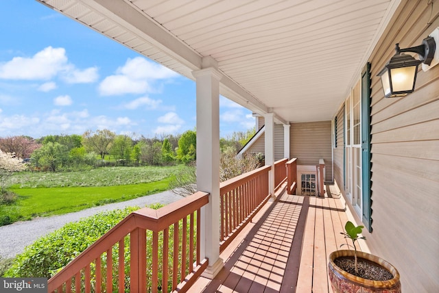 deck with a lawn and covered porch