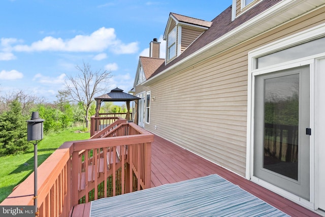 deck featuring a yard, a gazebo, and stairs