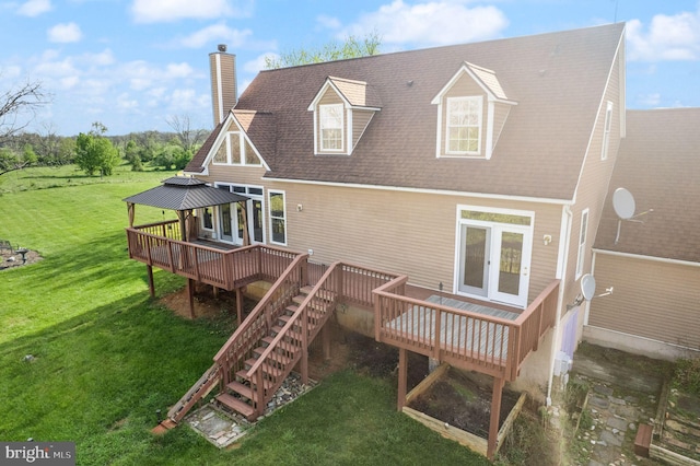 back of property featuring a gazebo, a wooden deck, a yard, and a chimney