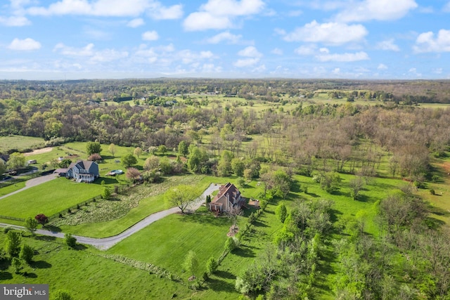 aerial view featuring a rural view and a wooded view