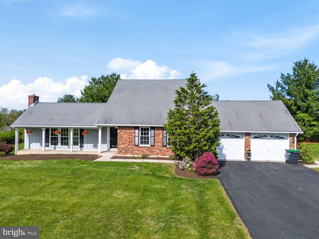 view of front facade with board and batten siding, a chimney, brick siding, aphalt driveway, and an attached garage