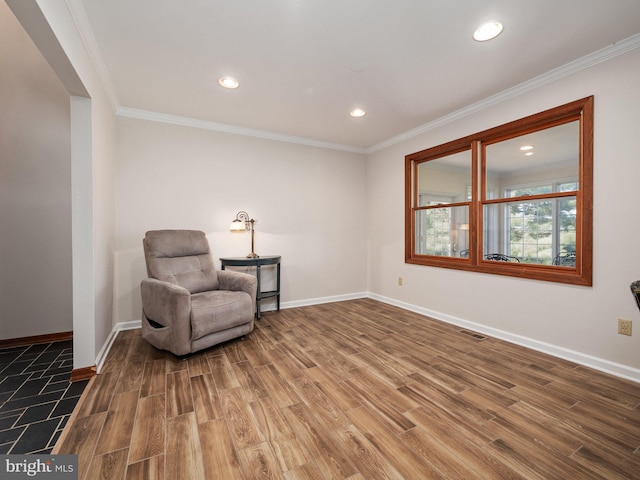 sitting room with baseboards, ornamental molding, recessed lighting, and wood finished floors