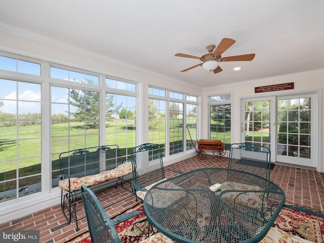 sunroom / solarium featuring french doors, ceiling fan, and a healthy amount of sunlight