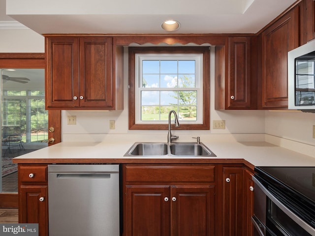 kitchen with light countertops, stainless steel appliances, plenty of natural light, and a sink