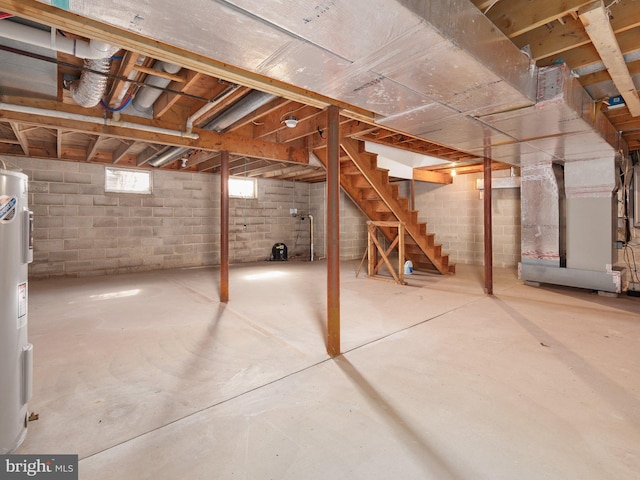basement featuring stairs and heating unit