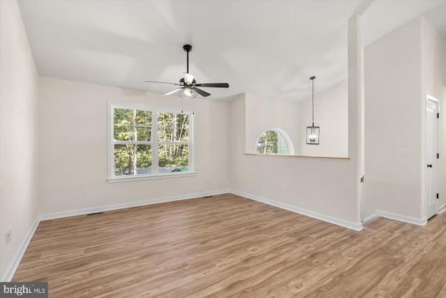 empty room with baseboards, light wood-style flooring, and ceiling fan