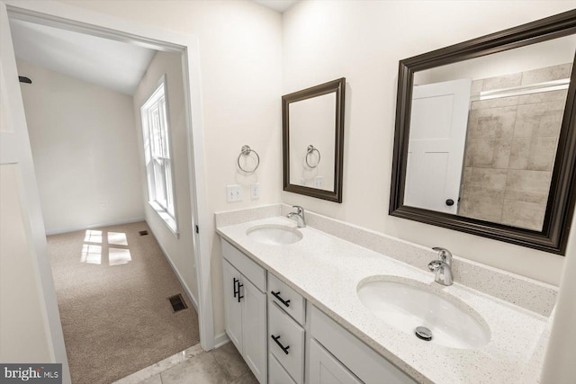 full bath featuring visible vents, a sink, baseboards, and double vanity
