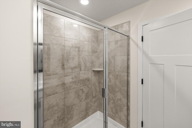 bathroom featuring recessed lighting and a stall shower