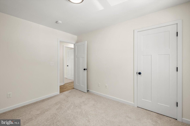 unfurnished bedroom featuring carpet floors and baseboards