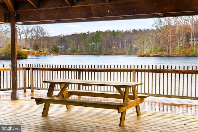 view of dock featuring a water view and a forest view