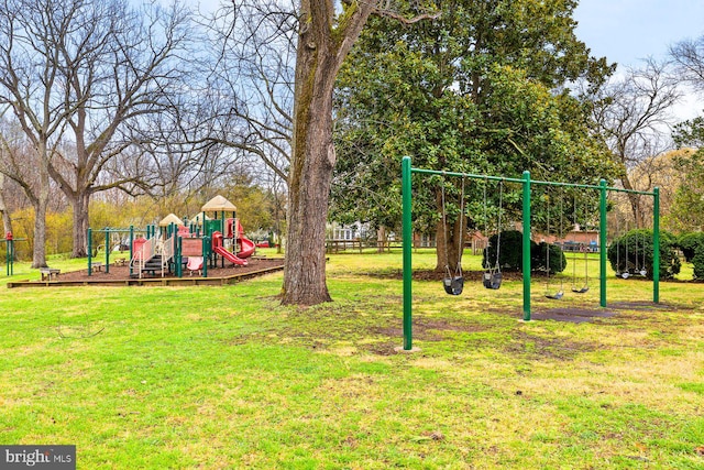 community jungle gym featuring a yard
