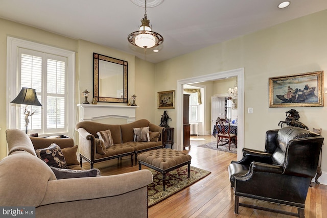 living room with recessed lighting, light wood finished floors, and radiator