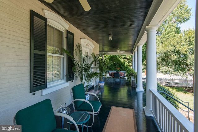 view of patio with a ceiling fan, fence, and covered porch