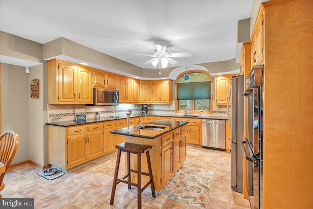 8 Winchester Ct, Tabernacle, NJ 08088 - kitchen featuring appliances with stainless steel finishes, a sink, decorative backsplash, a center island with sink, and a ceiling fan