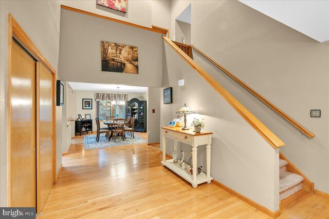 8 Winchester Ct, Tabernacle, NJ 08088 - staircase featuring a chandelier, wood finished floors, a high ceiling, and baseboards