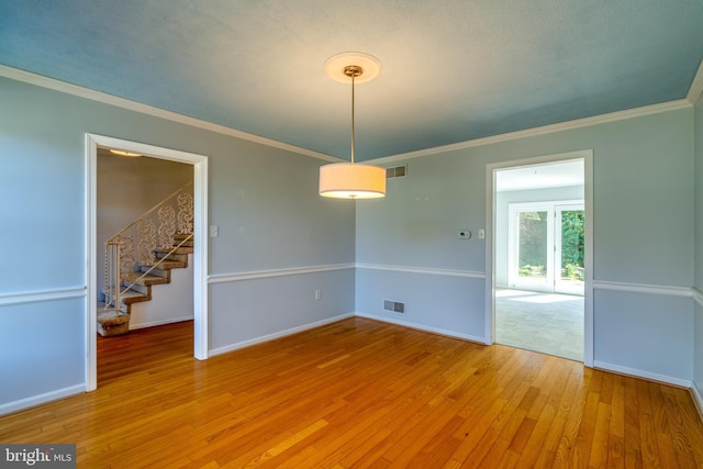 1114 Colonial Rd, Lancaster, PA 17603 - empty room featuring stairway, crown molding, light wood-style flooring, and visible vents