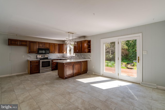 1114 Colonial Rd, Lancaster, PA 17603 - kitchen with black microwave, open shelves, stainless steel range with electric stovetop, light countertops, and a peninsula