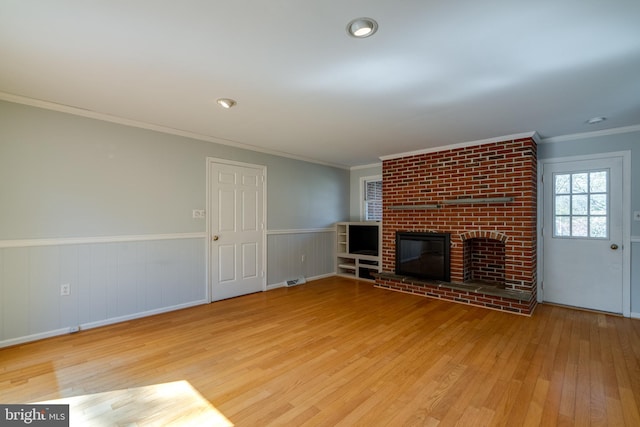1114 Colonial Rd, Lancaster, PA 17603 - unfurnished living room with crown molding, a wainscoted wall, wood finished floors, and a fireplace