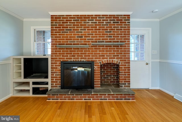 1114 Colonial Rd, Lancaster, PA 17603 - room details with a brick fireplace, wainscoting, ornamental molding, and wood finished floors