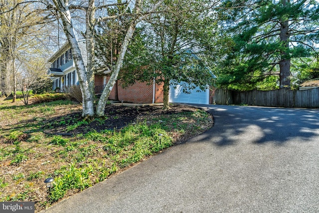 1114 Colonial Rd, Lancaster, PA 17603 - view of side of property with brick siding, a garage, fence, and aphalt driveway