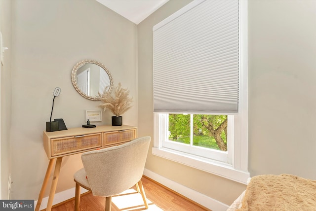 home office featuring baseboards and wood finished floors