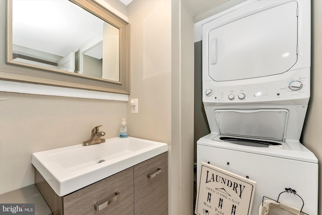 washroom with laundry area, stacked washer and clothes dryer, and a sink