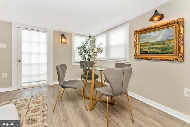 dining room with plenty of natural light, wood finished floors, and baseboards