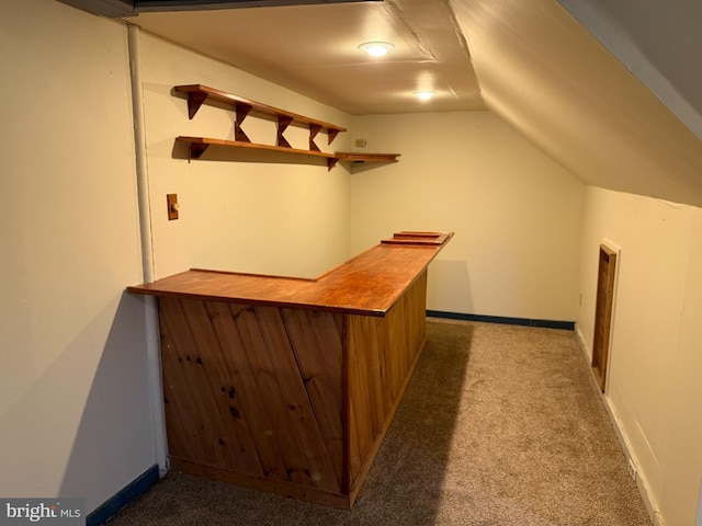 bar with baseboards, a dry bar, carpet, and lofted ceiling