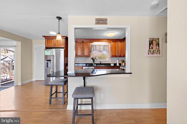 412 Prospect Ave, Pine Beach, NJ 08741 - kitchen with a kitchen breakfast bar, a sink, high end refrigerator, and light wood-type flooring