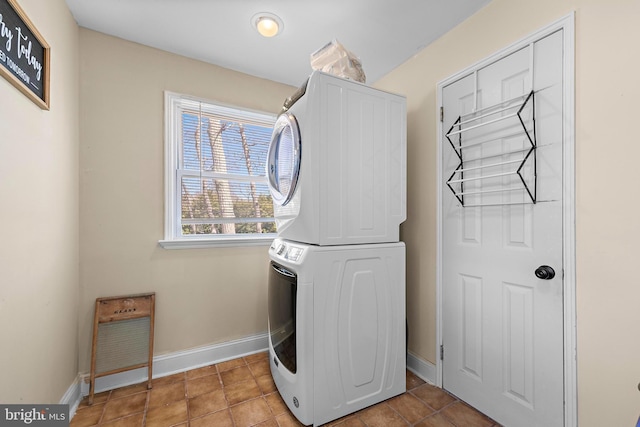 412 Prospect Ave, Pine Beach, NJ 08741 - laundry area with laundry area, stacked washer and clothes dryer, baseboards, and light tile patterned floors