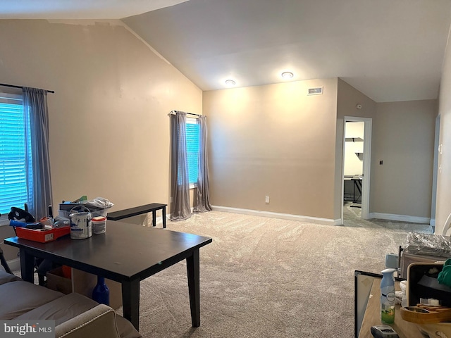 office space with visible vents, carpet flooring, and lofted ceiling