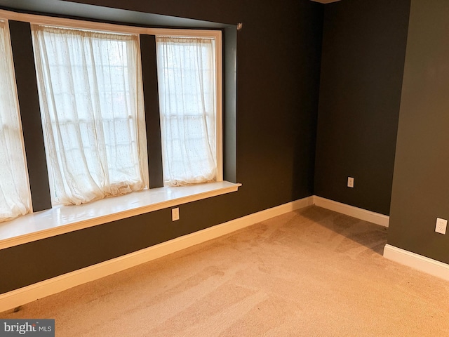 empty room with carpet floors and baseboards