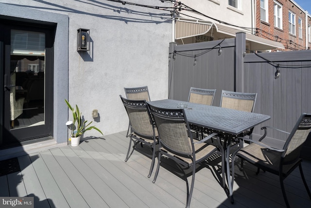 wooden deck with outdoor dining space