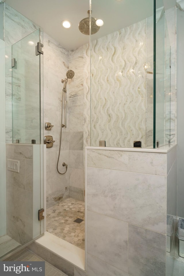 full bathroom featuring recessed lighting and a shower stall