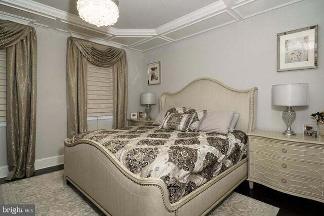 bedroom with baseboards and wood finished floors