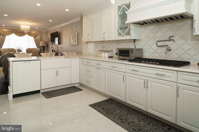 kitchen with stainless steel gas cooktop, a toaster, custom exhaust hood, a peninsula, and ornamental molding
