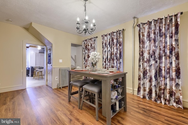 731 Locust St, Columbia, PA 17512 - dining room featuring a textured ceiling, an inviting chandelier, wood finished floors, and radiator