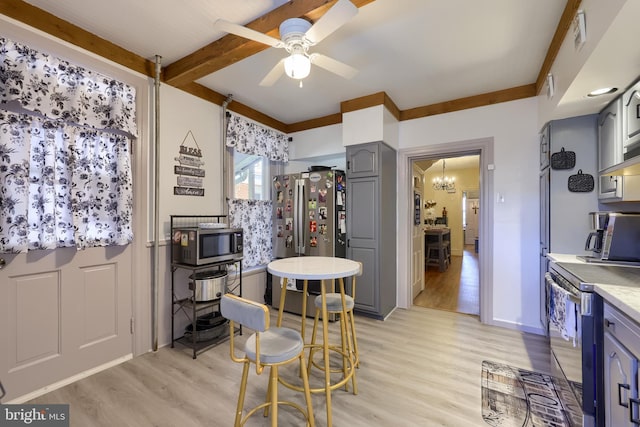 731 Locust St, Columbia, PA 17512 - dining space with beam ceiling, a toaster, baseboards, ceiling fan with notable chandelier, and light wood-style floors