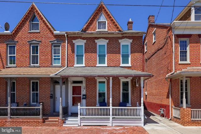 731 Locust St, Columbia, PA 17512 - view of front of house with a porch, a chimney, and brick siding