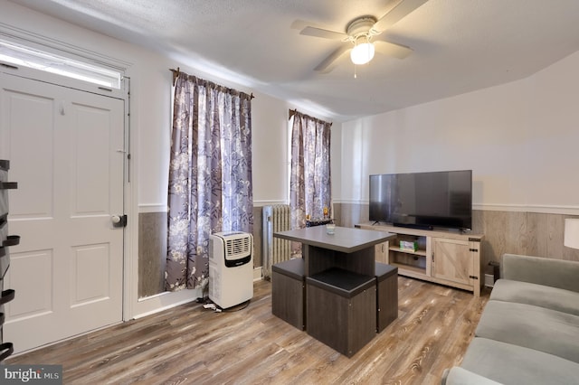 731 Locust St, Columbia, PA 17512 - office area featuring light wood finished floors, ceiling fan, a wainscoted wall, and radiator