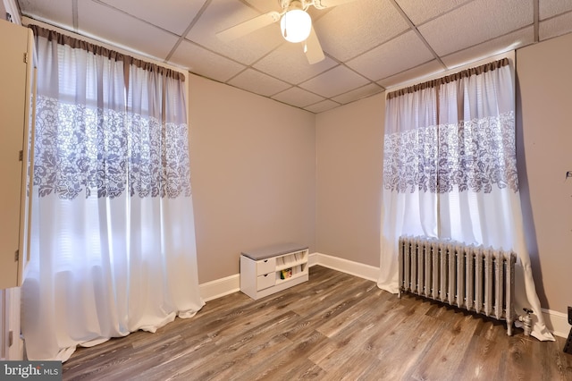 731 Locust St, Columbia, PA 17512 - spare room with radiator, wood finished floors, baseboards, ceiling fan, and a drop ceiling